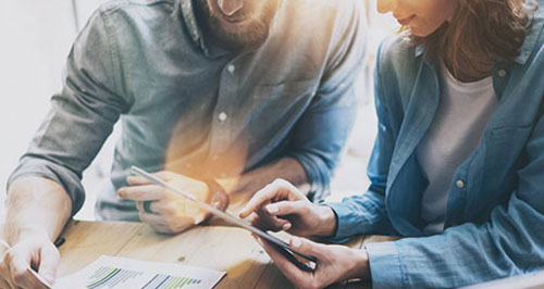man and woman looking at bills